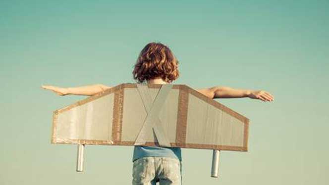 Child with cardboard wings on her back