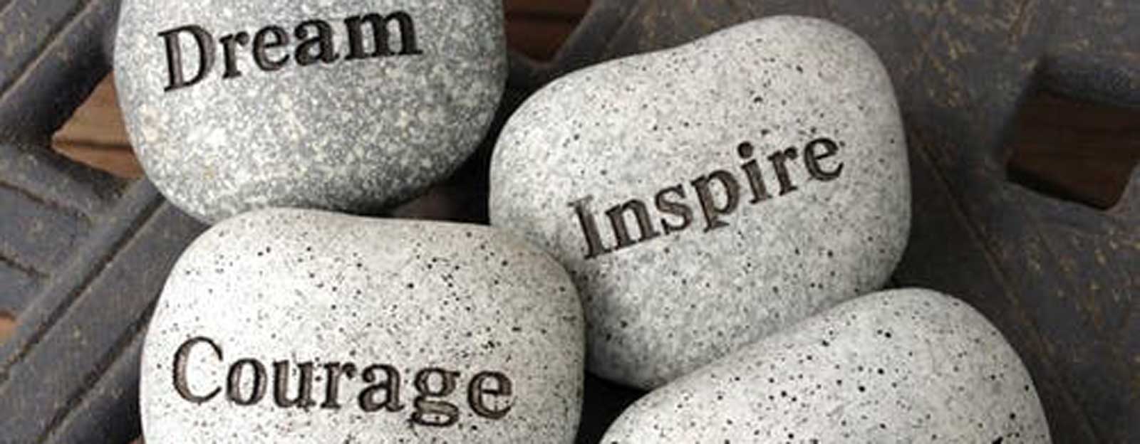 Rocks with the words dream, inspire, and courage engraved into them