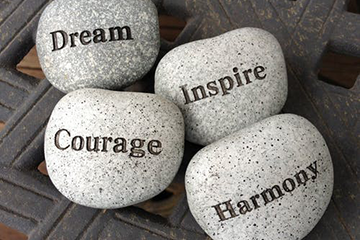 Rocks with dream, courage, inspire and harmony written on them
