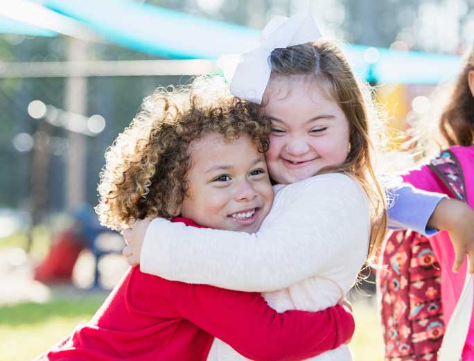 Two little girls hugging